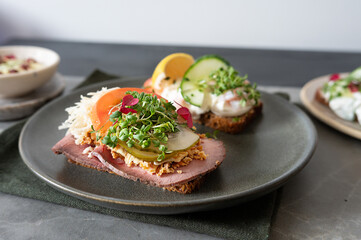 Smorrebrod, scandinavian traditional open sandwiches with roast beef and shrimps and eggs.