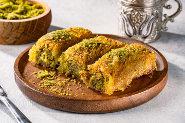 Delicious Turkish dessert pistachio kadayif. Burma kadayif on white background