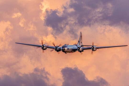 FIFI B-29 Superfortress Soaring at Sunset with Illuminated Clouds