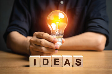 Innovation Concept with Glowing Bulb and Human Touch