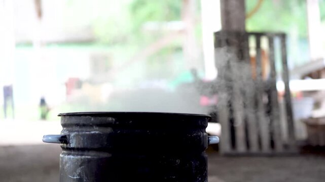 Large black saucepan on the fire. Cooking food at fire in wild
