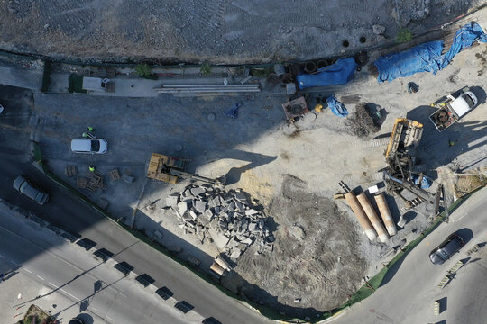 Aerial view of construction site with heavy machinery and building materials under the bright sun, &Auml;&deg;stanbul, &Auml;&deg;stanbul, T&Atilde;&frac14;rkiye.