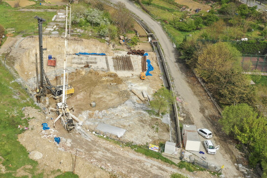 Aerial view of construction site with heavy machinery and equipment amidst earth and greenery, seemingly on the outskirts of the city, &Auml;&deg;stanbul, &Auml;&deg;stanbul, T&Atilde;&frac14;rkiye.