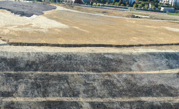 Aerial view of a construction site with dark, layered earth contrasting against the light, barren land, showing a stark transformation, &Auml;&deg;stanbul, &Auml;&deg;stanbul, T&Atilde;&frac14;rkiye.
