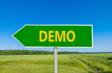 Demo symbol. Concept word Demo on beautiful green road sign. Beautiful blue sky green grass and forest peaceful nature background. Business and demo concept. Copy space.