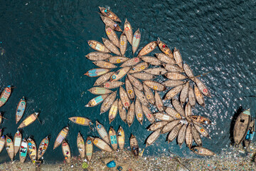 Aerial view of traditional boats clustered closely together in the water, creating a captivating mosaic of textures and colors, Dhaka, Dhaka District, Bangladesh.