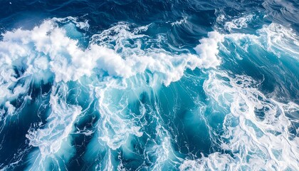 Close up aerial view of turbulent ocean waves crashing with white foam and deep blue water