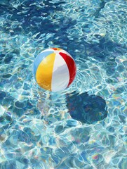 Obraz premium Beach ball floats in sunny pool; summer fun