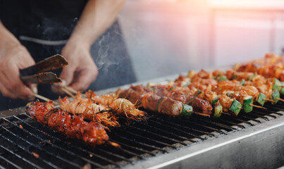 Grilled skewers on barbecue grill with shrimp and vegetables