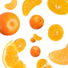 Sweet tangerines whirling in air against white background