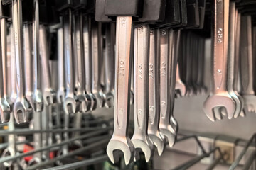 Hanging assortment of steel wrenches in a well-organized workshop