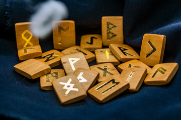 Runes lie on a black background with a flying smoky ring	
