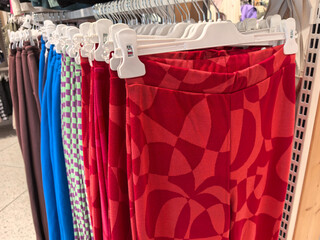 Brightly colored pants displayed in vibrant designs at a retail store