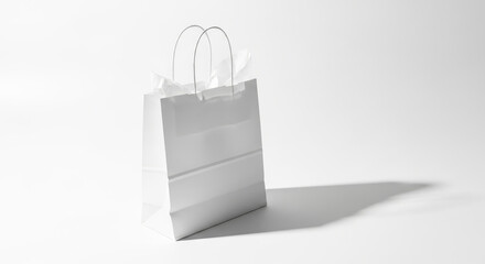 White paper shopping bag with handles isolated on white background