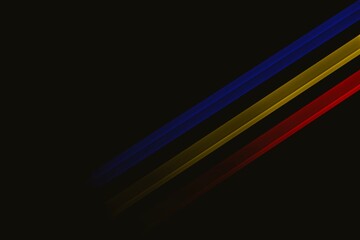 Diagonal stripes in red blue and yellow on black background