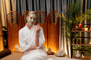 Serene ambiance of spa salon, woman customer indulges in rejuvenating with luxurious face cream...