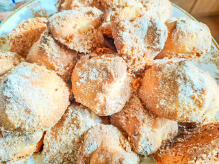 Shaped shortbread cookies covered with sugar powder surrounded by kitchen