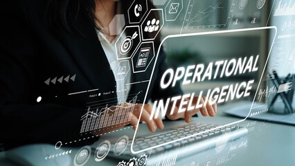 Professional woman working on laptop with operational intelligence graphics in modern office environment for business analysis. Asymptotic smart data analytic.