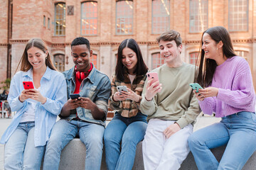 A lively group of friends joyfully engaging with their smartphones, sharing laughter and moments of...