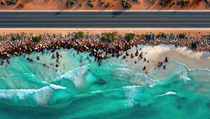 High-angle view of a coastal highway alongside a turquoise ocean.