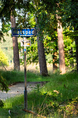Fietspad sign indicating cycle path in dutch forest during summer day