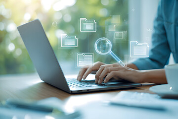 Person typing on a laptop with digital file icons and a magnifying glass overlayed on the image