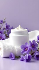 Lavender flowers and cream on a soft towel