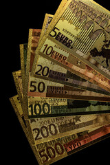 Stack of Various Euro Banknotes Arranged on a Black Background