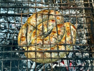 cooking sausages grill on an outdoor 