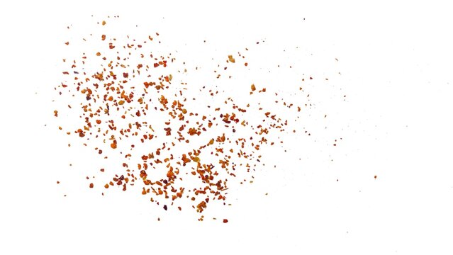 Sprinkle of chopped hot red chili peppers or paprika, paprika or red chili powder isolated on white background. Crushed red chili or chopped paprika. A pile of ground red chili or paprika.
