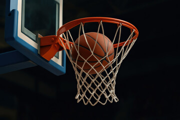 Fototapeta premium basketball in a basket, goal, on a black background close-up