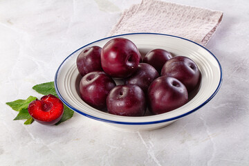 Raw ripe purple plum heap