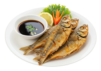 A plate of fried fish with a dipping sauce, lemon wedge, and lettuce garnish presented on white dish on transparent background