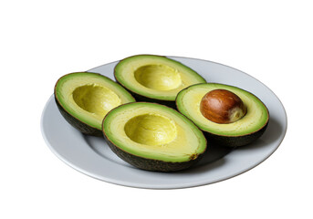 Four avocado halves arranged on a white plate with one containing the seed in an isolated setting on transparent background