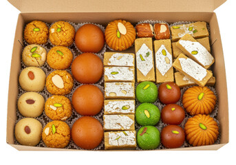 Assorted sweets in a cardboard container featuring various colors and textures arranged neatly inside the box on transparent background