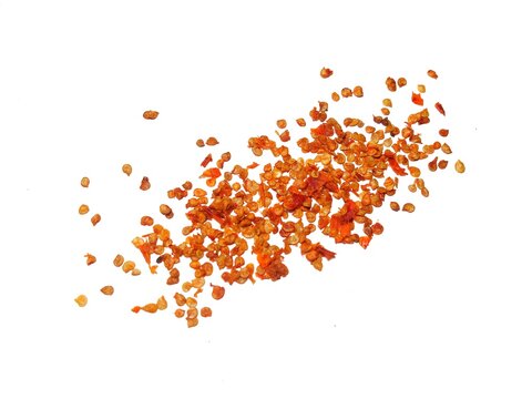 Dried red chili flakes and dried red chili seeds isolated on white background. Pile of crushed red chili peppers or paprika. Sprinkle of chopped hot red chili peppers or paprika. - Powered by Adobe