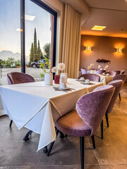Elegant restaurant interior with window view, set tables and cozy atmosphere. High quality photo