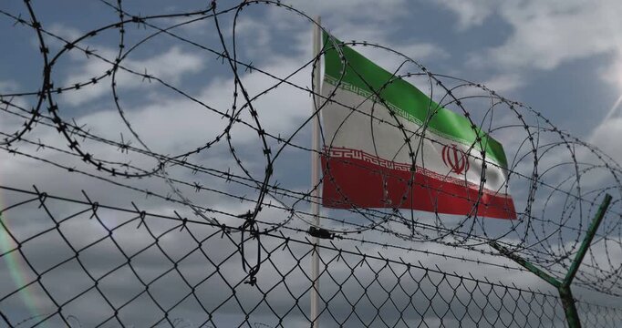 Iran waving flag on country border concept. Iranian blowing banner with barbed wire fence.