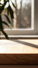 hazy sunlight streaming in illuminating a close-up of an empty wooden table.