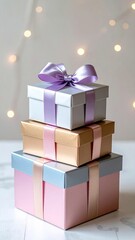 Stacked Gift Boxes in Pink Gold and Silver with Purple Ribbons and Bokeh Lights