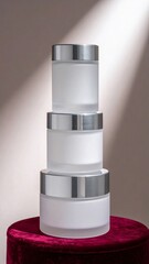 Cosmetic Skincare Jars Stacked on Burgundy Velvet Table with Dramatic Light