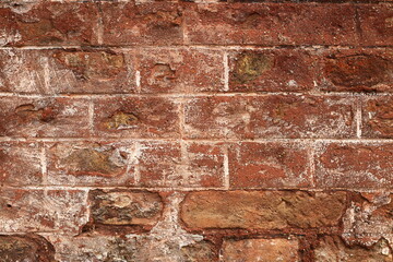 Old brick wall texture, weathered red bricks, rustic surface, exposed mortar, uneven brickwork, chipped and crumbling areas, historic building facade, vintage construction, urban decay aesthetic, arch