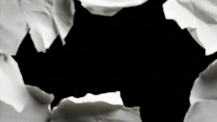 White ripped paper creating hole revealing black background - Powered by Adobe