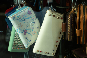 Colorful wallets and purses displayed in a shop window showcasing various styles and designs