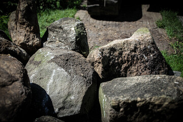 a collection of large, rough-hewn boulders used for the construction of retaining walls, rip rap, and erosion control projects. abstract background with copy space