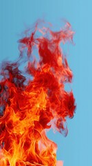 Intense flames against a clear blue sky background