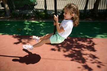 Young Girl Enjoying Playground Zipline on a Sunny Day