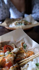 Close-up of Caucasian woman eating pan-Asian cuisine