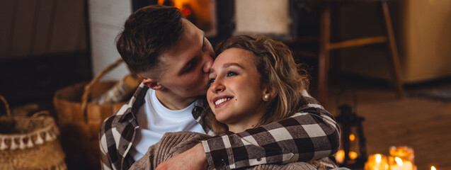 Romantic surprise for Saint Valentine's Day, christmas, new year. Weekend in the mountains in a countryside chalet house. Cozy atmosphere, relax. Candles, garlands, fireplace. Marriage proposal banner