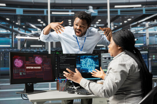 Data center engineers terrified by malicious attack on artificial intelligence computerized systems. Afraid AI server room colleagues frightened by hacking passing firewall security